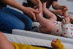 Person som masserar ett spädbarns fötter